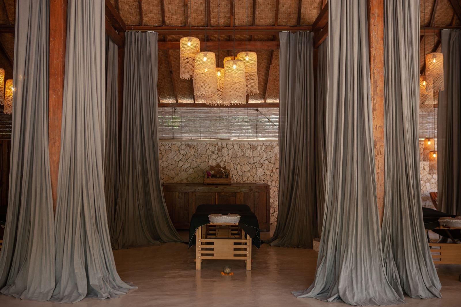 The shi•ra treatment room, with linen curtains and candlelight