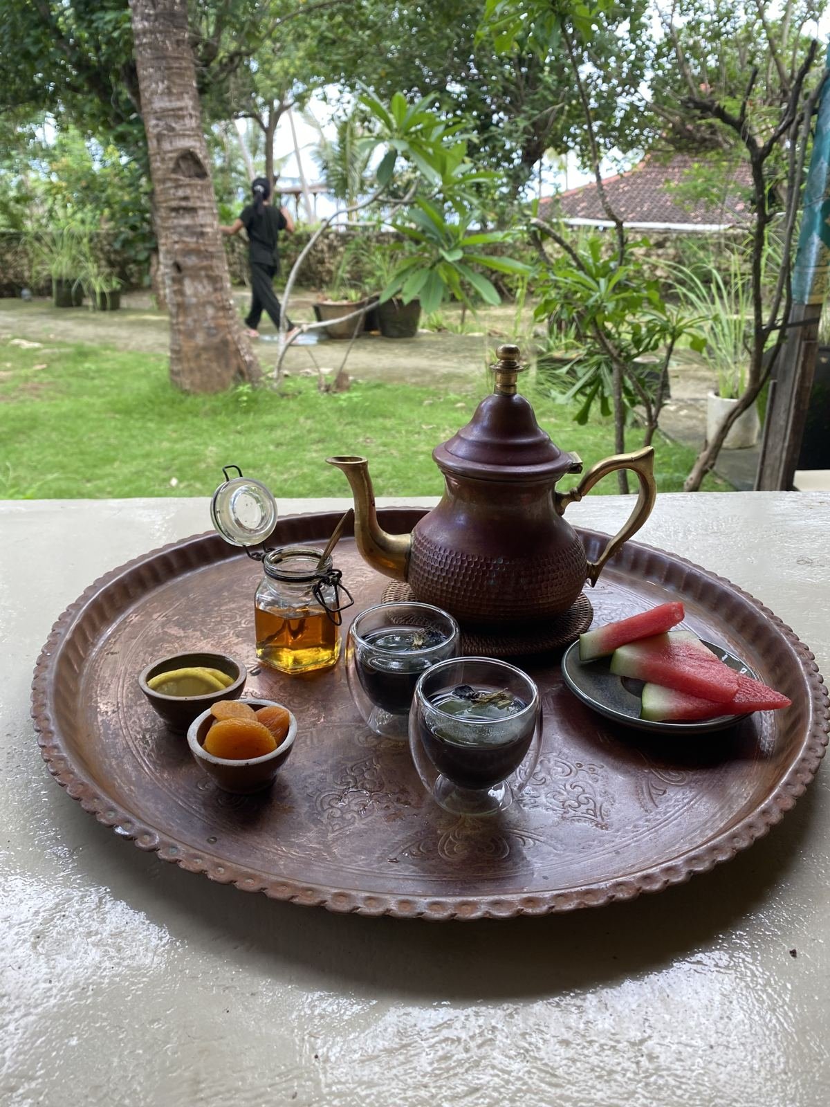 Ginger tea served on a copper tray in the garden